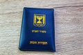 Passport Israel on a wooden background passport booklet, translated from the Hebrew and Arabic :Ministry of Interior, ID