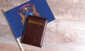 Passport and a Michigan flag on a wooden background. Royalty Free Stock Photo