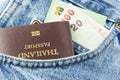 Passport and money in jeans pocket Royalty Free Stock Photo