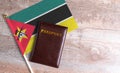 Passport and a Mozambique flag on a wooden background