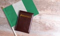Passport and a Nigeria flag on a wooden background