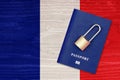Passport and padlock on the background of the flag of France. Ban on leaving the country. Travel abroad is closed. French flag and
