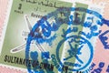 Passport page with the Sultanate of Oman visa and immigration control stamp. Royalty Free Stock Photo
