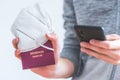 Passport pandemic vacation concept: Close up of man holding a passport, ffp2 protection mask and smartphone, Ã¢â¬ÅReisepass Passport