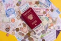 Passport with paper money and coins. Flatlay of vacation on a yellow background Royalty Free Stock Photo