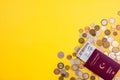 Passport with paper money and coins. Flatlay of vacation on a yellow background Royalty Free Stock Photo