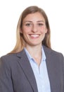 Passport picture of a blond businesswoman in a blazer