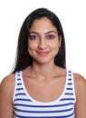 Passport picture of a smiling turkish woman in a striped shirt