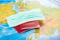 2 passports on the background of the map and a medical mask Royalty Free Stock Photo