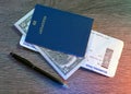 Passports, Boarding Pass, Dollars, Pen lying on wooden table Royalty Free Stock Photo