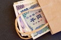 Japanese yen currency in a brown paper bag. Royalty Free Stock Photo
