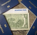 4 passports, 2 dollars and boarding pass on wood background, family travel concept Royalty Free Stock Photo