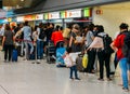 Passsengers wait at a TAP customer service counter at departure Hall of Lisbon international airport, the largest in the