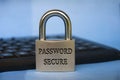 Password secure text engraved on padlock with blurred keyboard background. Password security concept Royalty Free Stock Photo