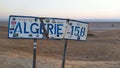 Chott el Jerid lake, Tunisia - June 29, 2019. Sign informed about distance to Algeria border on the roadside of causeway crossing