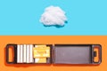 Past and present music inspired concept. Open box with cassette and cotton cloud shaped prop against blue and terracotta