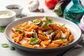 Pasta alla Norma. Traditional Italian dish with eggplant, tomato sauce, ricotta cheese and basil in plate on concrete background Royalty Free Stock Photo