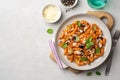 Pasta alla Norma. Traditional Italian dish with eggplant, tomato sauce, ricotta cheese and basil in plate on concrete background Royalty Free Stock Photo