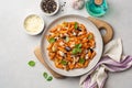 Pasta alla Norma. Traditional Italian dish with eggplant, tomato sauce, ricotta cheese and basil in plate on concrete background Royalty Free Stock Photo