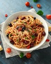 Pasta Alla Puttanesca with garlic, olives, capers, tomato and anchois fish Royalty Free Stock Photo