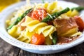 Pasta with asparagus, tomato and prosciutto