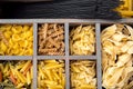 Pasta assortment in wooden box cells. Royalty Free Stock Photo