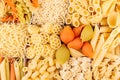 Pasta background assortment of different kinds italian macaroni in chess cells top view.