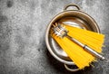Pasta background. Spaghetti in a pot with a ladle. Royalty Free Stock Photo