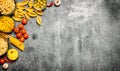 Pasta background. Various pasta with spices and vegetables. Royalty Free Stock Photo
