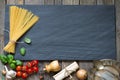 Pasta basil tomato garlic food abstract background concept on black marble Royalty Free Stock Photo