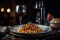 Pasta with beef and tomato sauce on a plate with a glass of red wine Royalty Free Stock Photo