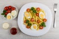 Pasta with boiled eggs, parsley, fork, saucer with tomato, eggs Royalty Free Stock Photo