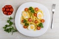 Pasta with eggs, tomatoes, parsley, fork, parsley, tomato cherry