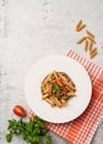 pasta with bolognese sauce with cherry tomatoes, cheese and parsley in white plate on concrete background Royalty Free Stock Photo