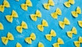 Pasta bow. Uncooked penne on blue background top view copy space Royalty Free Stock Photo