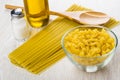 Pasta in bowl, spaghetti, spoon, salt, bottle of vegetable oil Royalty Free Stock Photo