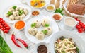 Pasta, bowls of various sauces, vegetables and soup pelmeni for lunch