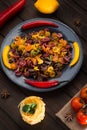 Pasta and burning peppers on a gray plate with tomatoes, sweet pepper, lemon, olives and olives on a wooden dark Royalty Free Stock Photo