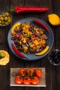 Pasta and burning peppers on a gray plate with tomatoes, sweet pepper, lemon, olives and olives on a wooden dark Royalty Free Stock Photo