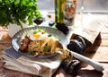 Pasta Carbonara on plate with bacon and egg plows on dark wood b