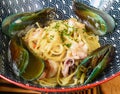 Pasta carbonara with sea food on blue plate isolated on black background side view Royalty Free Stock Photo