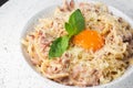 Pasta Carbonara. Spaghetti with bacon, parmesan, cream sauce and egg yolk. Macro close-up isolated on a white round Royalty Free Stock Photo