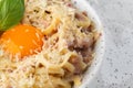 Pasta Carbonara. Spaghetti with bacon, parmesan, cream sauce and egg yolk. Macro close-up isolated on a white round Royalty Free Stock Photo