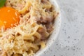 Pasta Carbonara. Spaghetti with bacon, parmesan, cream sauce and egg yolk. Macro close-up isolated on a white round Royalty Free Stock Photo