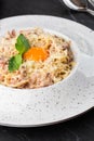 Pasta Carbonara. Spaghetti with bacon, parmesan, cream sauce and egg yolk. Macro close-up isolated on a white round Royalty Free Stock Photo