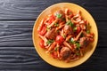 Pasta Casarecce recipe with meat balls, herbs and cheese in tomato sauce closeup on a plate. horizontal top view Royalty Free Stock Photo