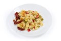 Pasta casserole with supplemented sun-dried tomatoes on white background Royalty Free Stock Photo