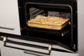 Pasta, cheese and ham gratin in an oven Royalty Free Stock Photo