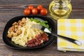 Pasta with chicken meat, ketchup and parsley, bottle of oil