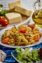 Pasta with tomato, basil leaf, garlic and parmesan